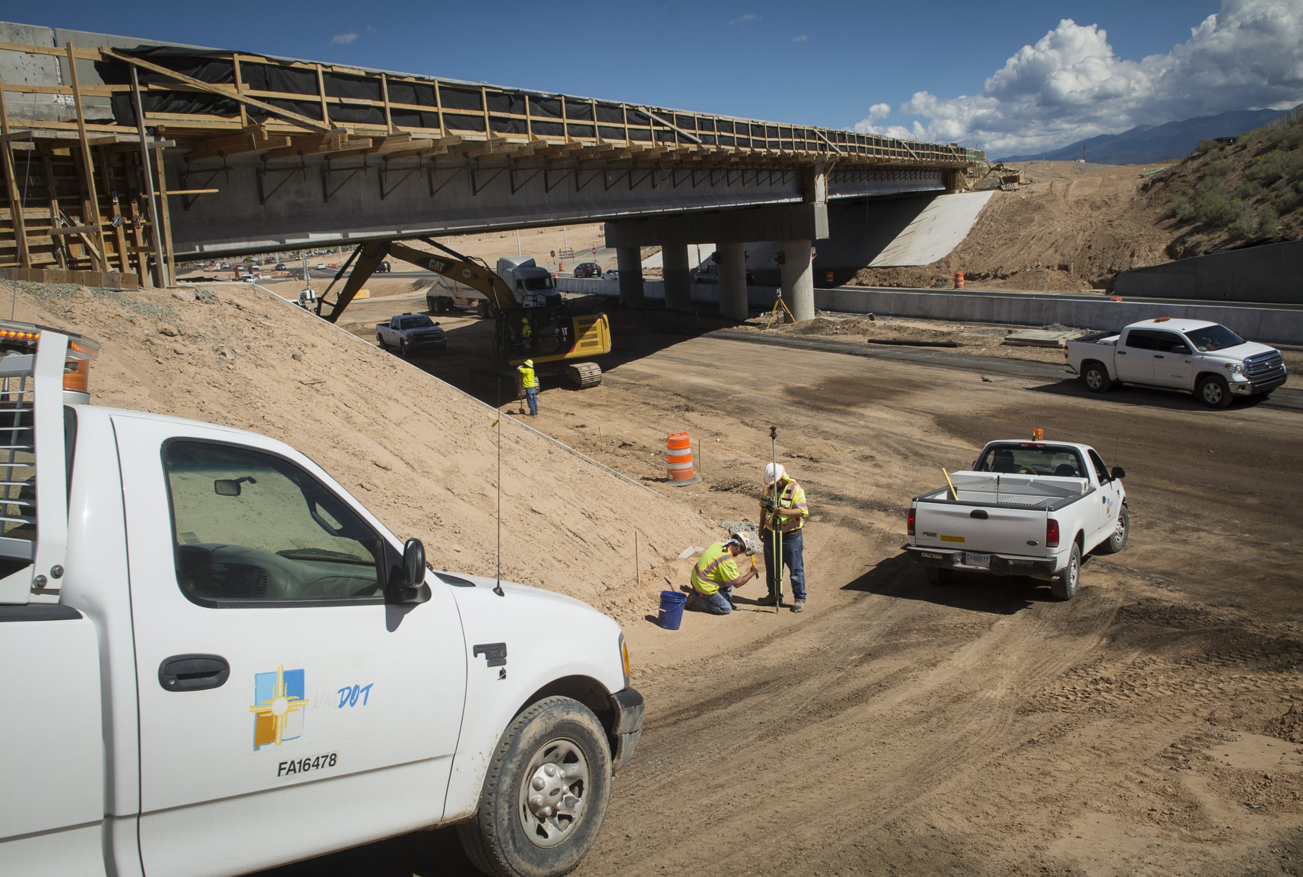 A picture of a bridge with several employees working
