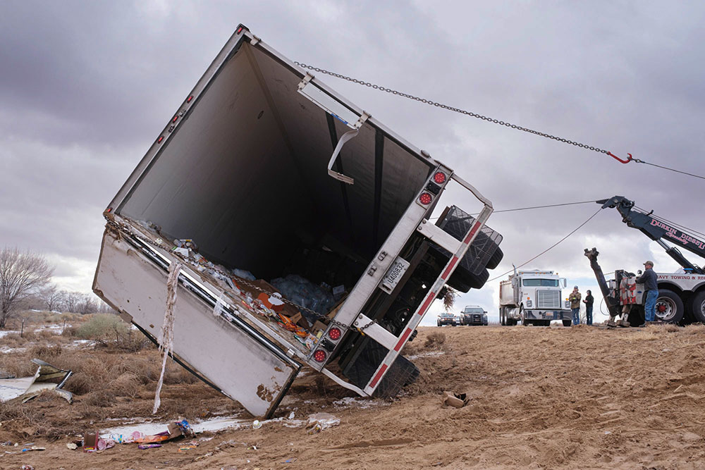 A photo of a semi on its side