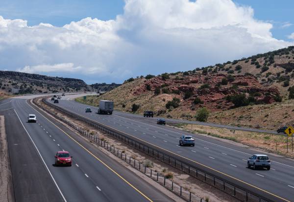 A photo of several cars driving on the freeway