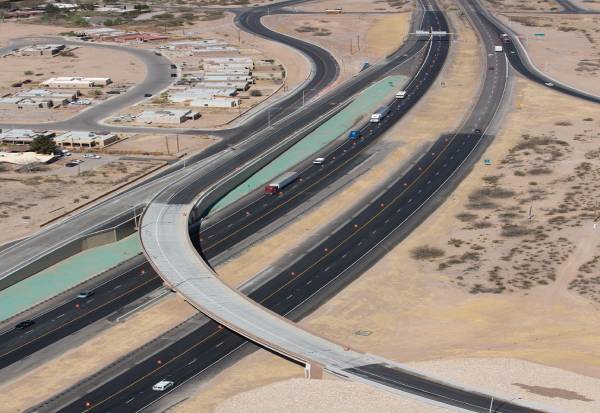 An aerial view of a road with semi-trucks driving on it