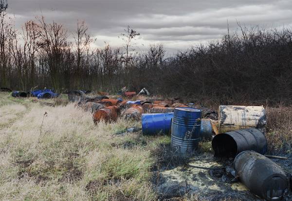 A photo of waste barrels on the ground