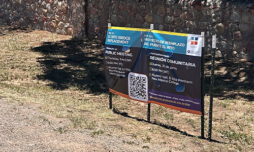 Roadside-Banner Image shows a roadside banner for a public meeting for an NMDOT project.
